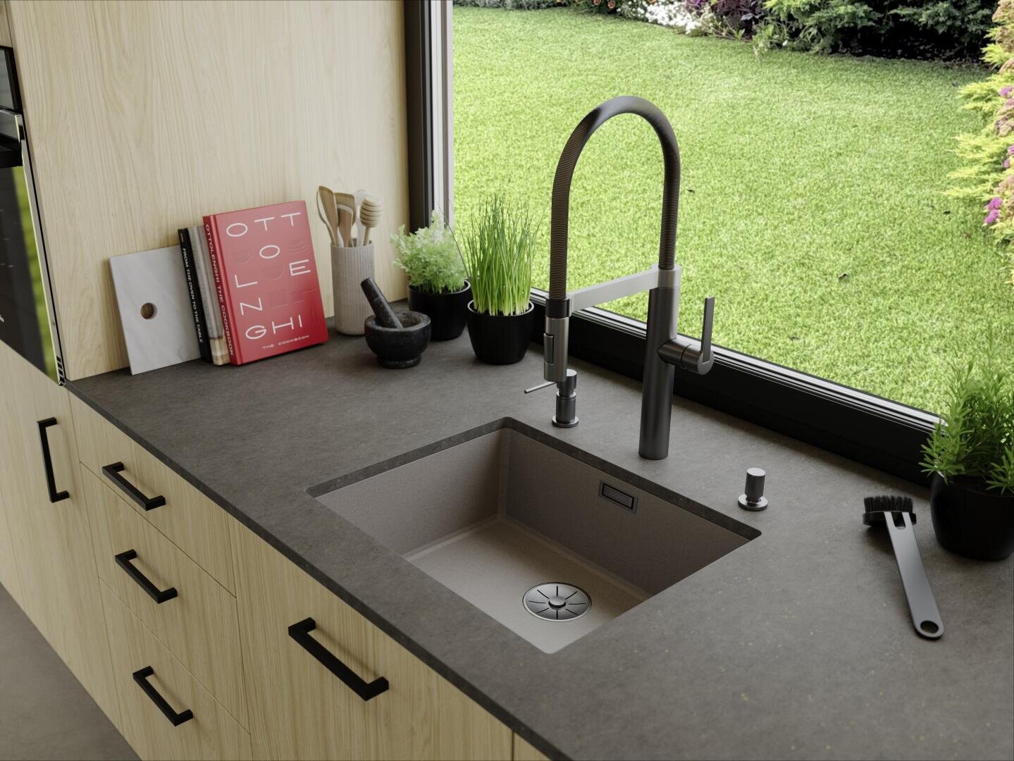 Eine moderne Küchenarbeitsplatte mit Spüle, schwarzem Wasserhahn, Topfpflanzen, Utensilien, einem Buch und einer Bürste steht an einem großen Fenster mit Blick auf einen grünen Rasen und Garten.
