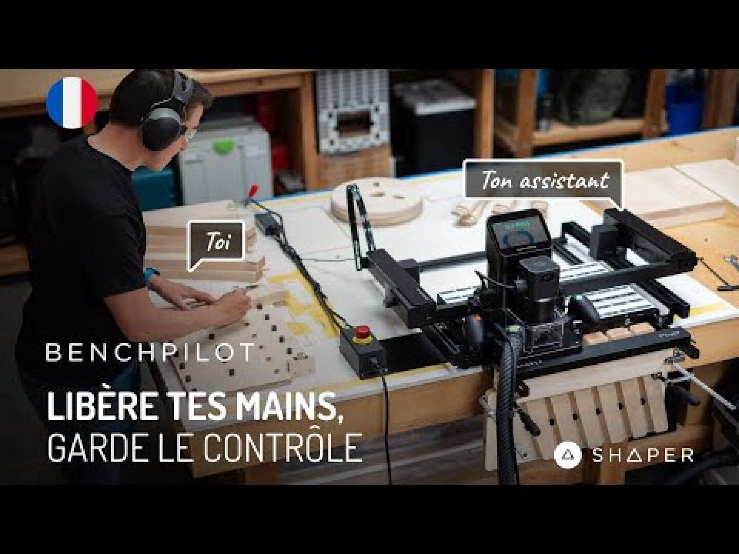 Une personne portant des écouteurs utilise un établi avec des outils de travail du bois et une machine CNC Shaper ; le texte français indique Libère tes mains, garde le contrôle.