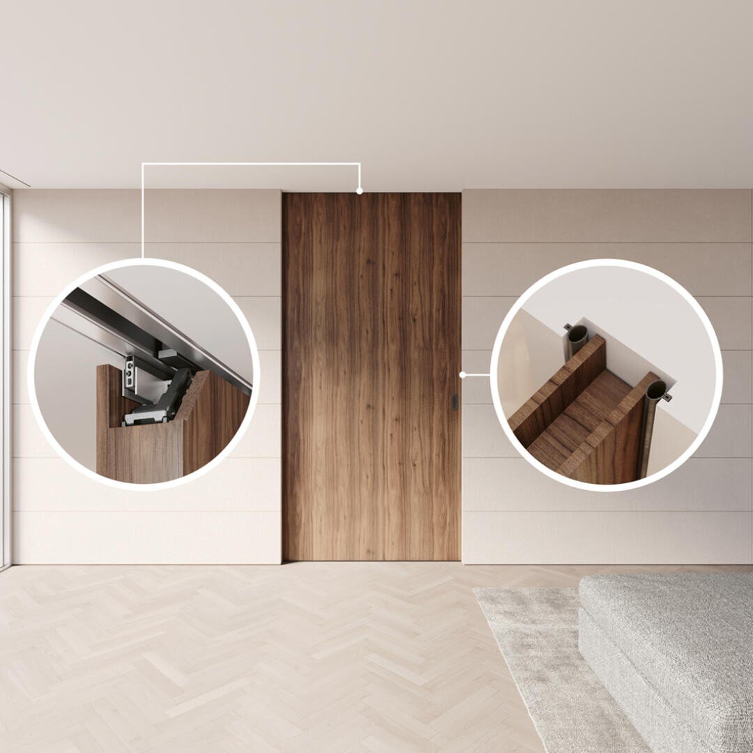 Eine moderne Holzschiebetür wird in einem minimalistischen Raum gezeigt. Zwei kreisförmige Einsätze betonen den oberen Laufschienenmechanismus der Tür und die Befestigung der Schiebebeschläge an der Tür.
